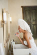 Mixed race woman brushing teeth in the morning