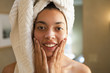 Mixed race woman rubbing face in the morning