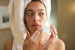 Mixed race woman rubbing face in the morning