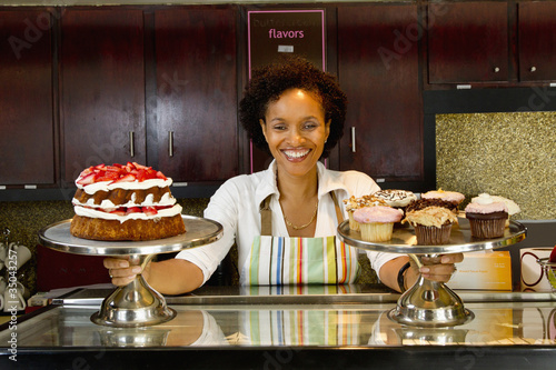Photo: African American bakery owner displaying baked goods African American bakery owner displaying baked goods