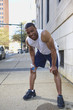 African American man leaning over after exercise
