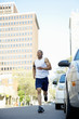 African American man running on city street