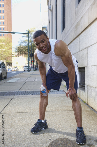 Photo: African American man leaning over after exercise African American man leaning over after exercise