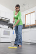 Hispanic woman mopping kitchen floor