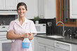 Hispanic maid cleaning kitchen