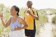 Black couple exercising on beach