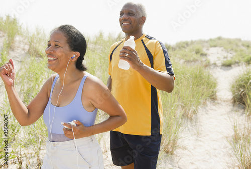 Photo: Black couple exercising on beach Black couple exercising on beach