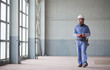 Hispanic worker in hard-hat walking indoors