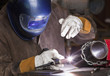 Mixed race machinist working at arc welding