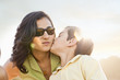 Son kissing mother on cheek outdoors