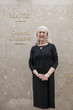 Caucasian businesswoman standing in office corridor