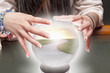 Mixed race fortune teller with crystal ball with road inside