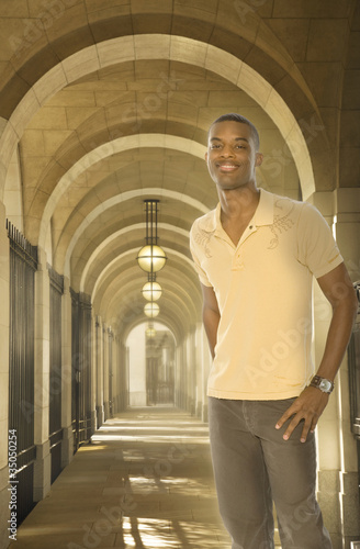 Photo: Black man standing in arched walkway Black man standing in arched walkway