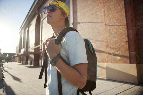 Photo: Caucasian man wearing sunglasses and backpack Caucasian man wearing sunglasses and backpack