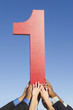 Business people lifting large number 1