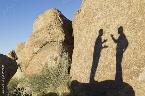 Photo: Shadow of businessmen talking in desert Shadow of businessmen talking in desert
