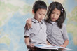 Korean children reading book near map