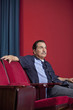 Hispanic man sitting in theater