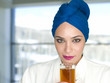 Caucasian woman in blue turban drinking tea
