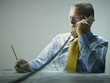 Caucasian businessman covered in cobwebs talking on telephone