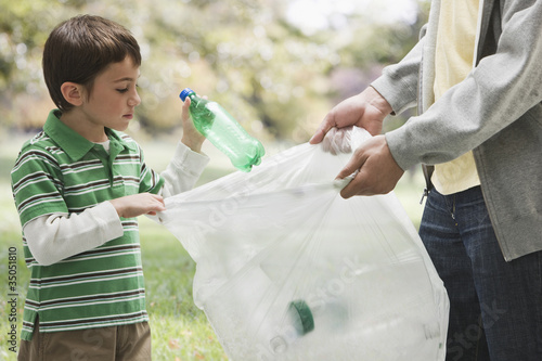 Foto: Caucasian father and son picking up litter together Caucasian father and son picking up litter together