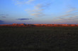Sunset over field and rock formation