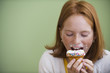 Caucasian girl making a mess eating a cupcake