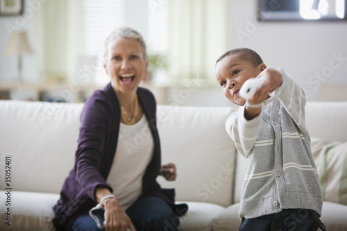 Photo: Grandmother and grandson playing video game Grandmother and grandson playing video game