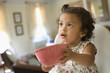 Hispanic girl holding out bowl