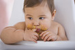 Messy mixed race baby boy sucking finger