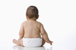 Mixed race baby boy sitting on floor
