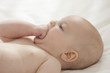 Caucasian baby girl biting fist