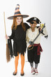 Children standing in witch and pirate costumes