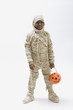 Black boy in mummy costume holding jack o'lantern