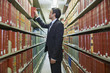 Hispanic businessman doing research in library