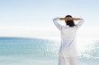 Mixed race woman standing near ocean