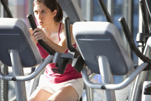 Photo: Woman exercising in health club Woman exercising in health club