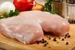 Raw chicken breasts on cutting board