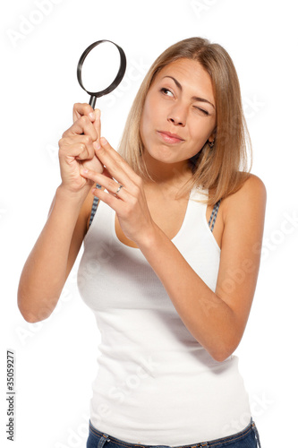 Photo: Young female looking through the loupe at copy space Young female looking through the loupe at copy space