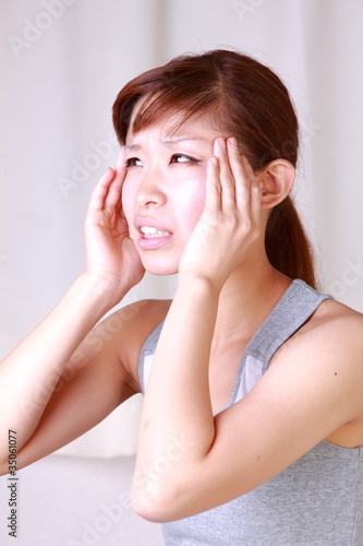 Photo: japanese woman woman suffers from headache japanese woman woman suffers from headache