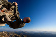 Photo: Young man climbing the rock high above mountain range Young man climbing the rock high above mountain range