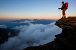 Photo: Man with backpack high above the misty mountain valley Man with backpack high above the misty mountain valley