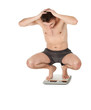 frightened squats on scale young man in panties