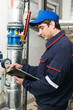heating engineer repairman in boiler room