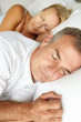 Head and shoulders mid age couple sleeping