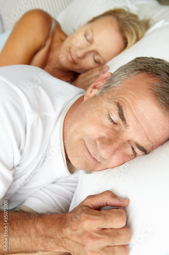 Photo: Head and shoulders mid age couple sleeping Head and shoulders mid age couple sleeping