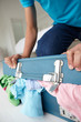 Teenage boy struggling to close suitcase