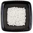 sugar homeopathy balls on black plate close up