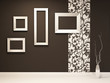 Showroom. Empty frames on the black wall with decoration