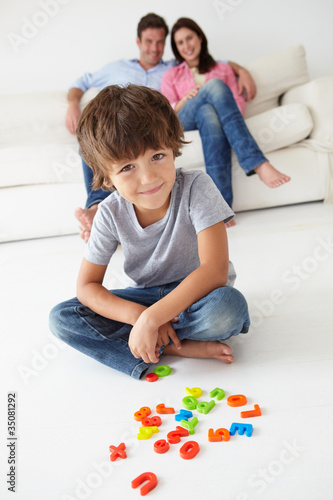 Photo: Parents watching son play Parents watching son play